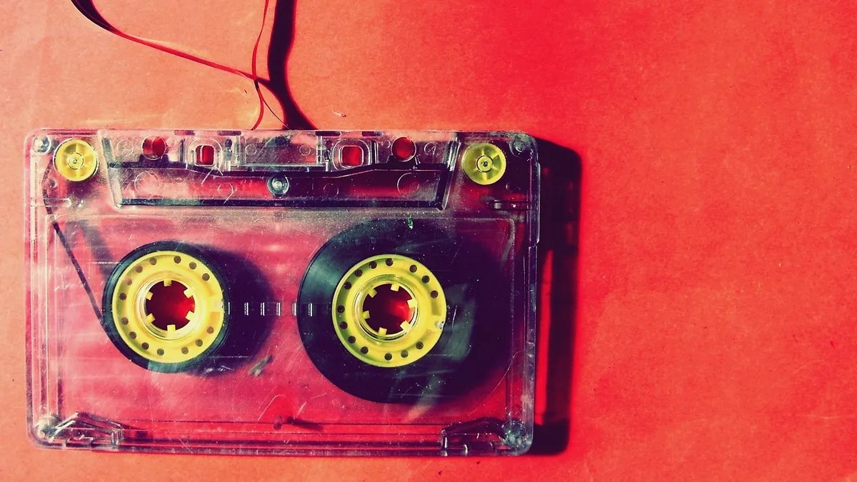 Retro 1980s cassette tape on a red background