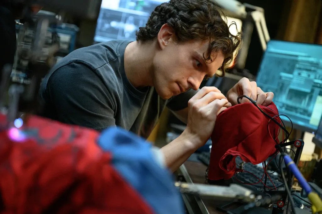 Peter Parker (Tom Holland) works on his suit in Spider-Man: Brand New Day (2026).