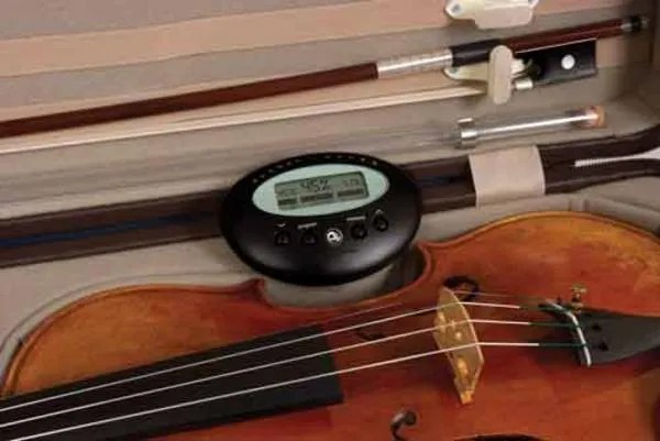 violin in case with hygrometer