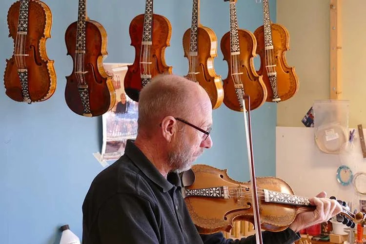 Hardanger fiddle maker Sigvald Rørlien holding a Hardanger fiddle