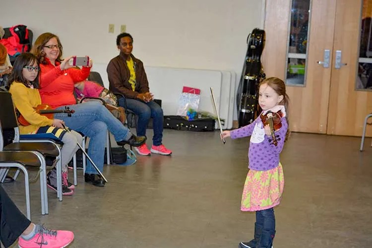 An HPSI student performs for the school community