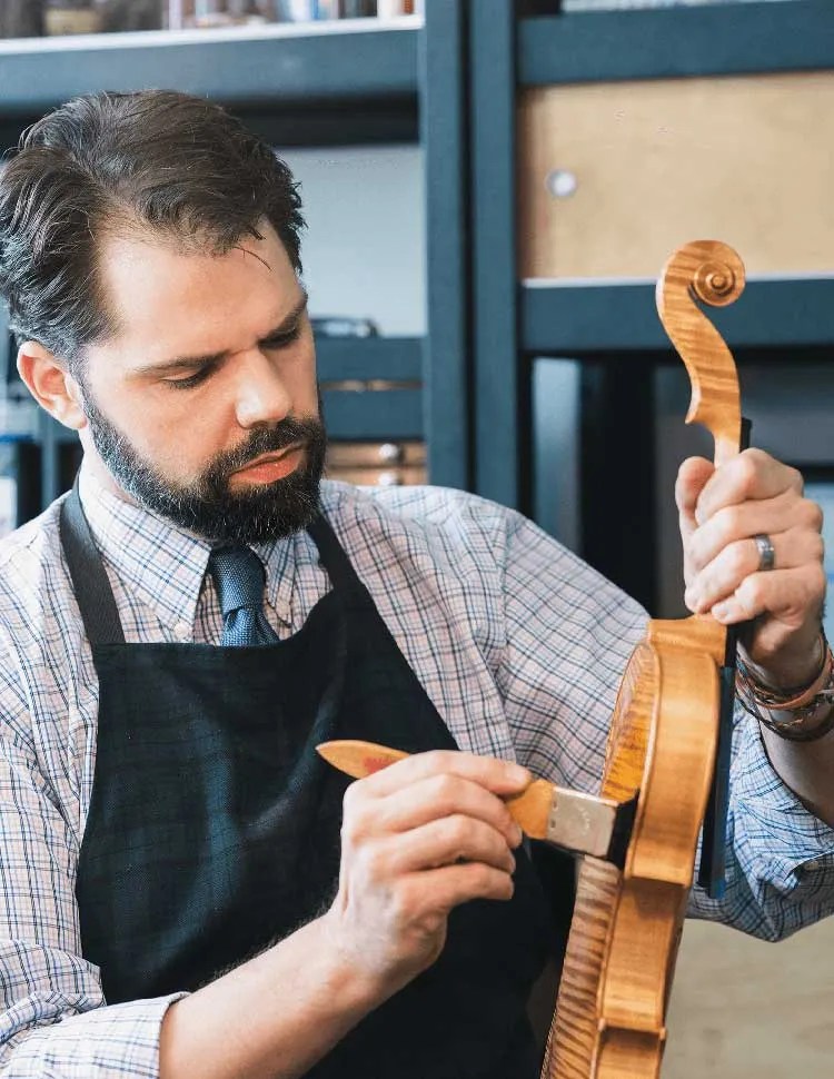 Ryan McLaughlin working on a violin