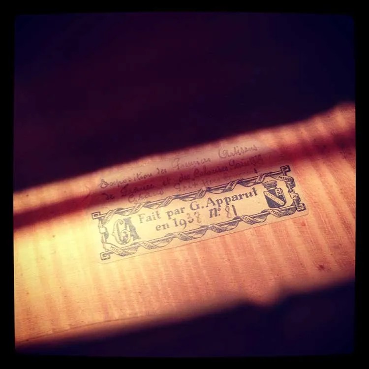 view of the makers mark through the soundhole of emily wright's cello