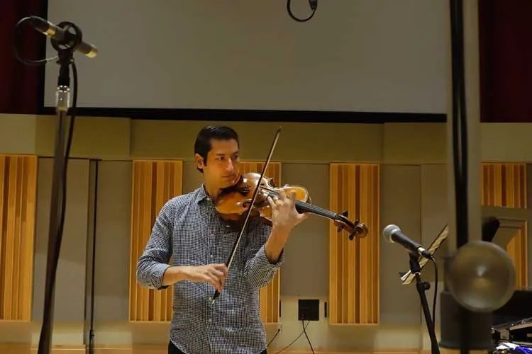 Violist Masumi Rostad recording on his instrument