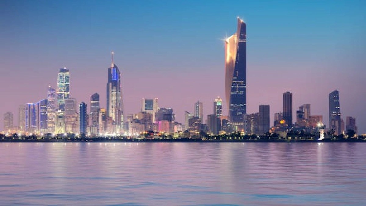 Now give Kuwait City skyline at dusk, representing Kuwait's focus on strengthening its skilled workforce and labour market through a partnership with Saudi Arabia.
