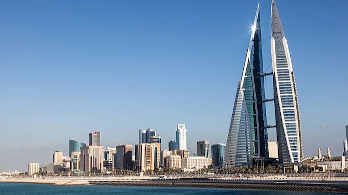 Bahrain AI Education initiatives are highlighted against the Manama skyline, featuring the Bahrain World Trade Center and waterfront.