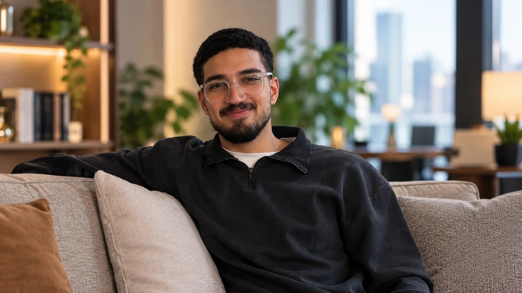 Ibrahim Isbaita, Vice President of the ASHRAE Student Branch at Kuwait University, seated on a sofa in a modern office.