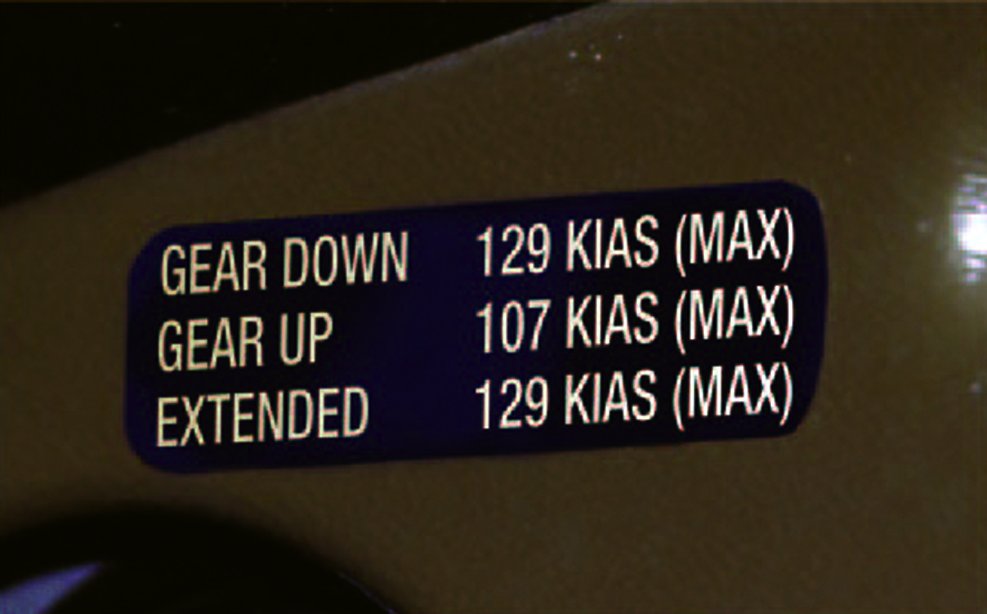Flight deck placard listing maximum airspeeds for gear down, gear up and gear extended