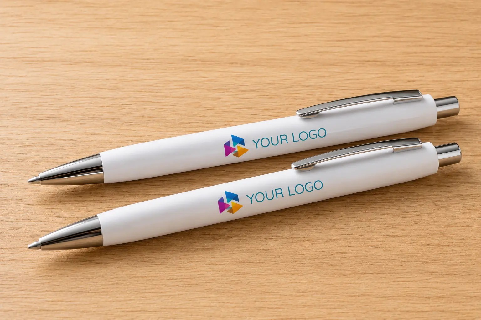Two white branded ballpoint pens printed with a full colour logo