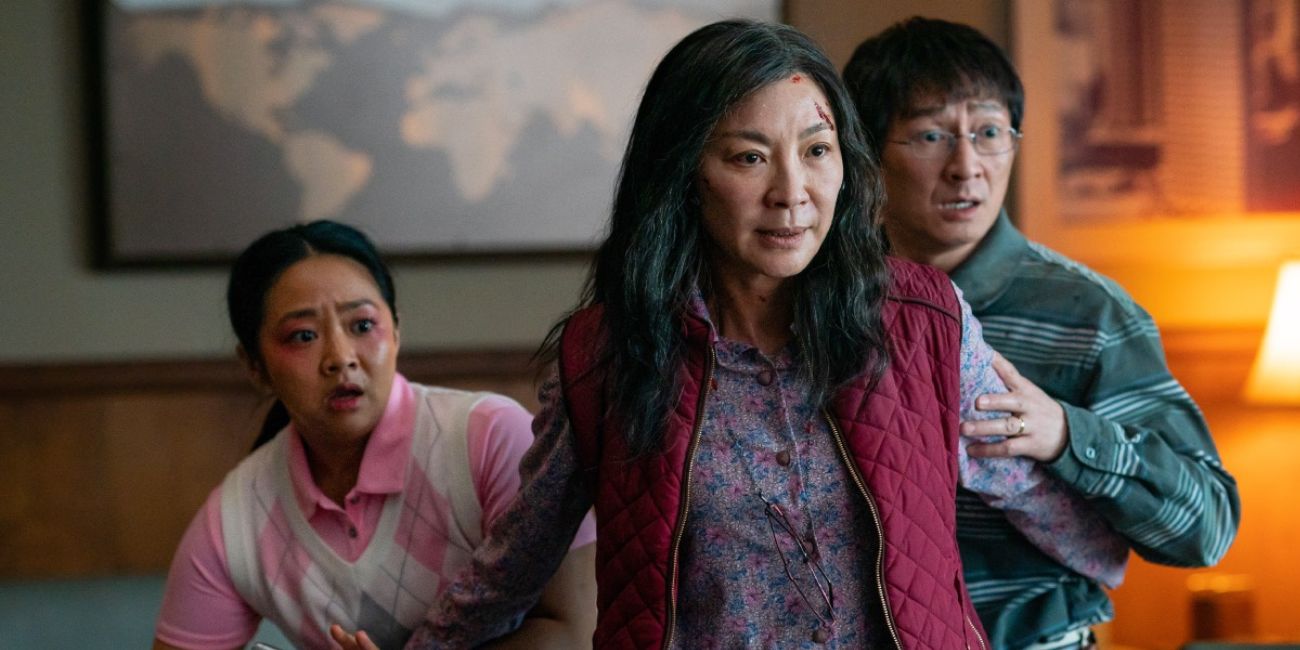 Michelle Yeoh as Evelyn protecting Stephanie Hsu,as Joy and Ke Huy Quan as Waymond in Everything Everywhere All at Once