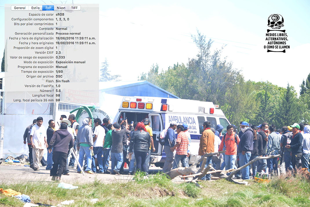 [Foto 11] 11:26:11 a.m. La ambulancia carga a varios heridos, entre ellos a Ancelmo Cruz Aquino.