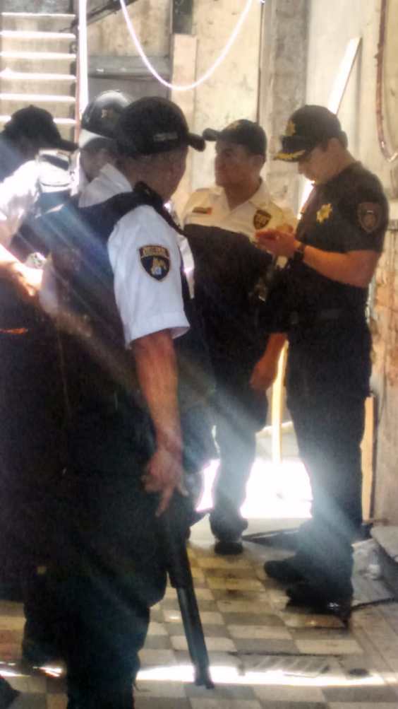 Elementos del CUSAEM custodian con armas largas los departamentos desalojados.
