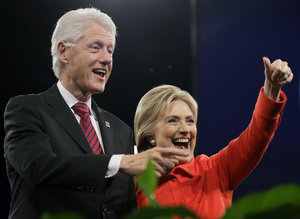 Former President Bill Clinton and his wife, Democratic presidential candidate Hillary Rodham Clinton, wave to supporters after the Iowa Democratic Party's Jefferson-Jackson fundraising dinner, Saturday, Oct. 24, 2015, in Des Moines, Iowa. (AP Photo/Charlie Neibergall)