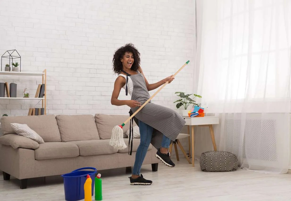 woman dancing while cleaning