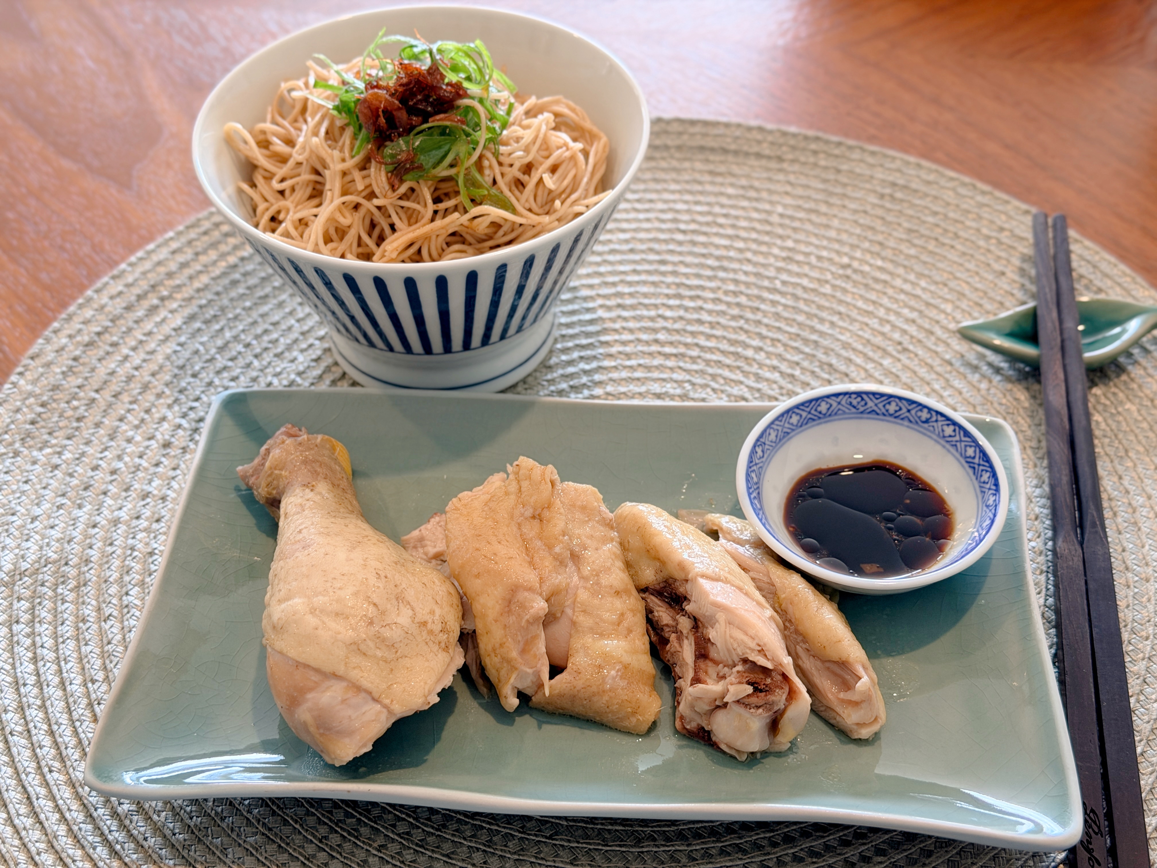 Cantonese-style slow-cooked chicken Maryland served on a green platter with soy dipping sauce and noodles