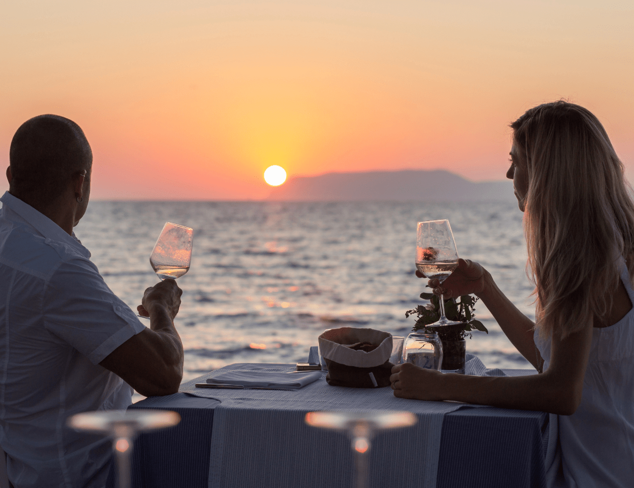 Sunset over the ocean with people relaxing