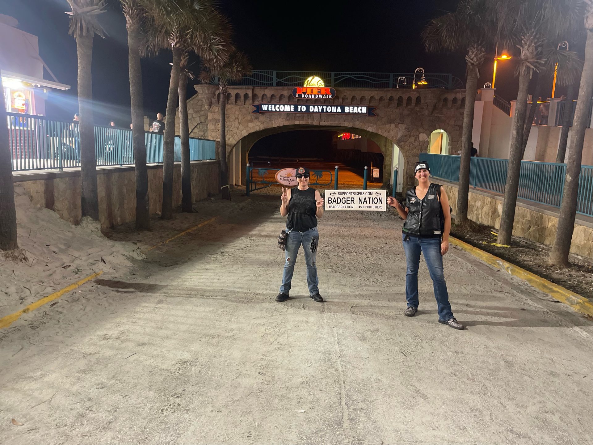 Daytona Beach hotels for Bike Week and Biketoberfest|Motorcycle Riders Sonny and Angie Badger outside a retro-style motel - Daytona Beach hotels|Daytona International Speedway entrance - Daytona Beach hotels|A well-known Daytona Beach hotel exterior with an American cruiser motorcycle in the foreground - Daytona Beach hotels
