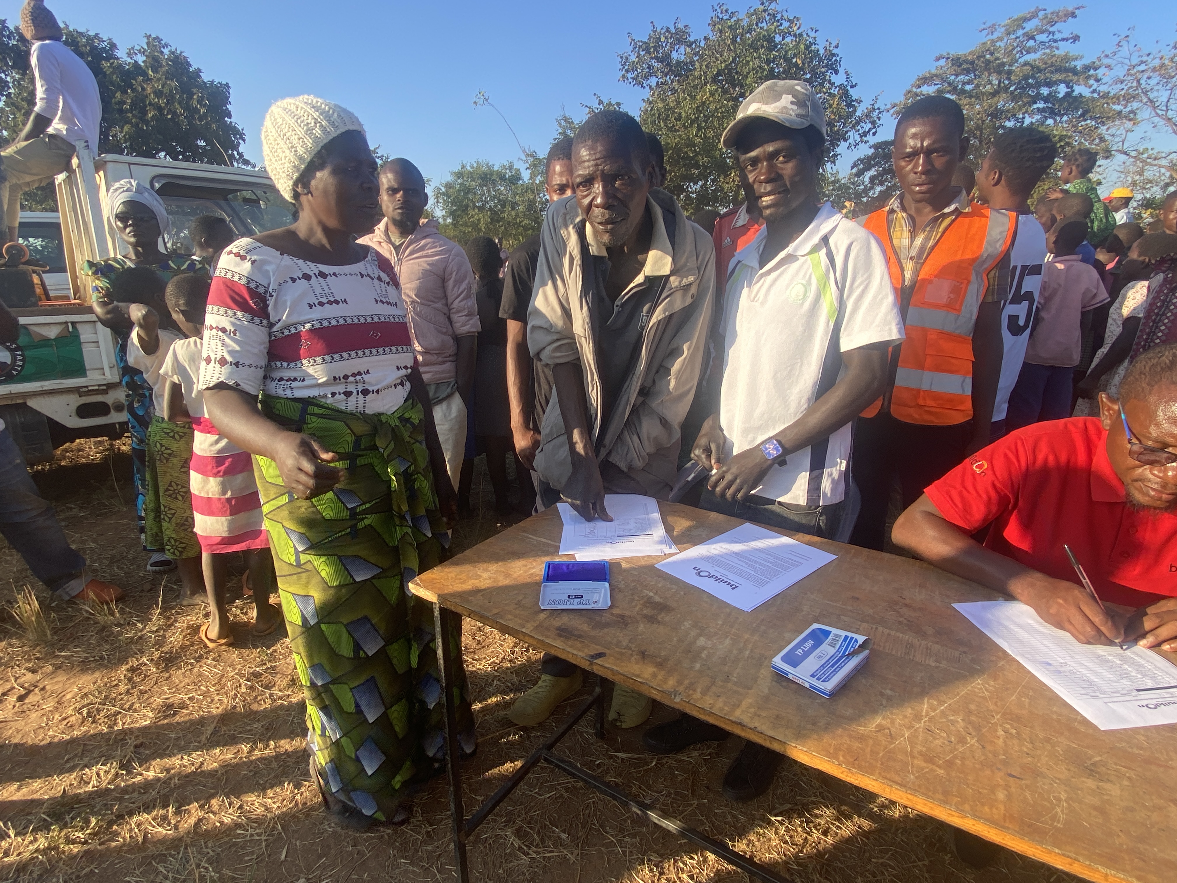 (PHOTO: A community member signs with covenant supporting the Team Dayā school in Lambwe, Malawi on Monday, June 23, 2025. He is signing with his thumbprint because he does not know how to write.)