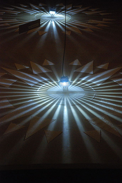 Detail of 'Compass' created by sieving dental plaster through a stencil I designed in the shape of a compass. other materials LED light and hardboard.