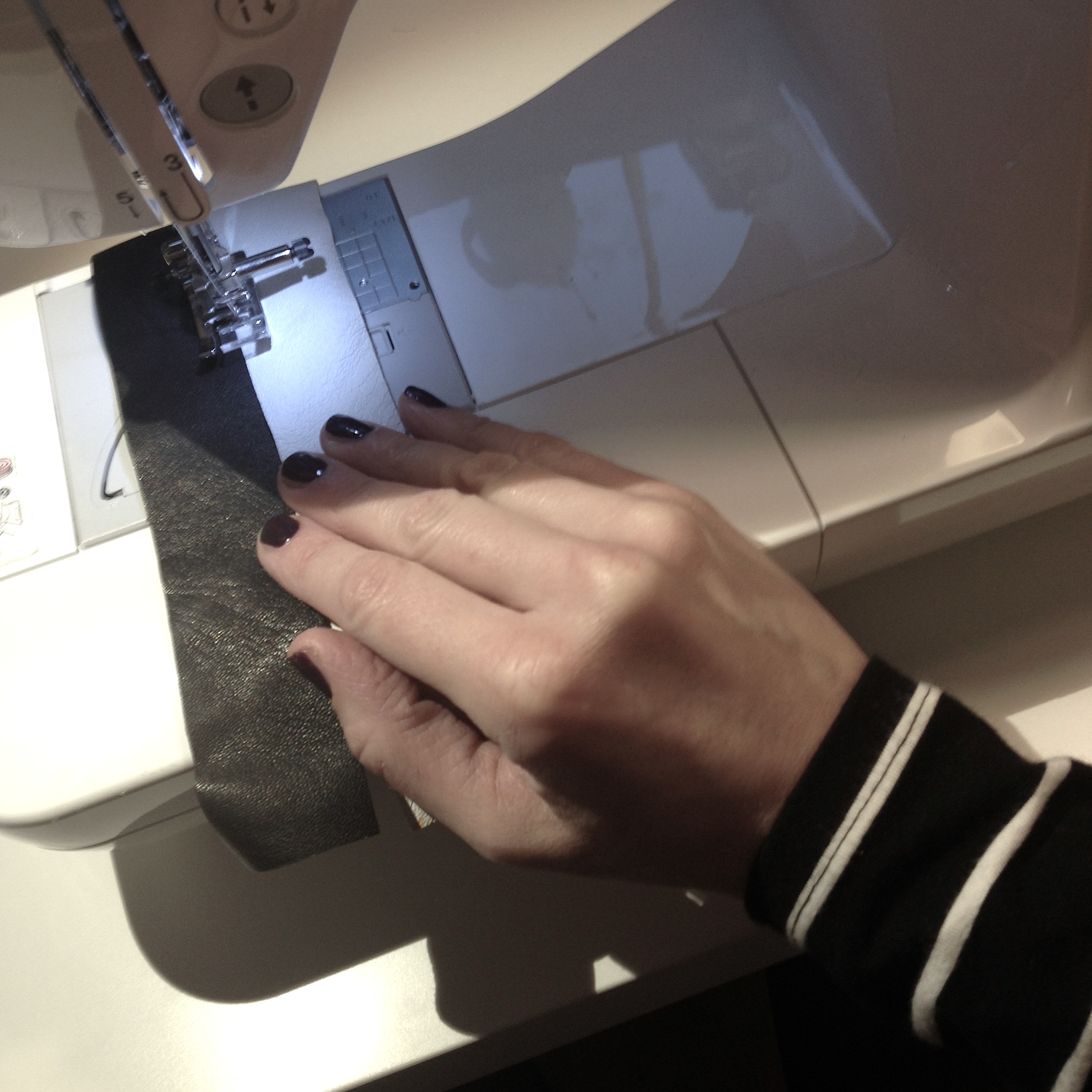 sewing together stripes of leather