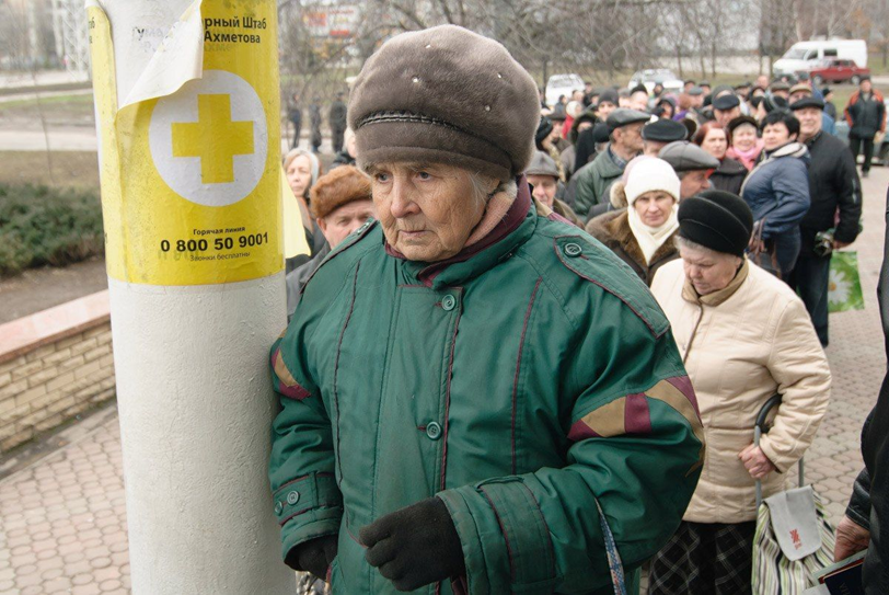 Woman waiting in line for food aid