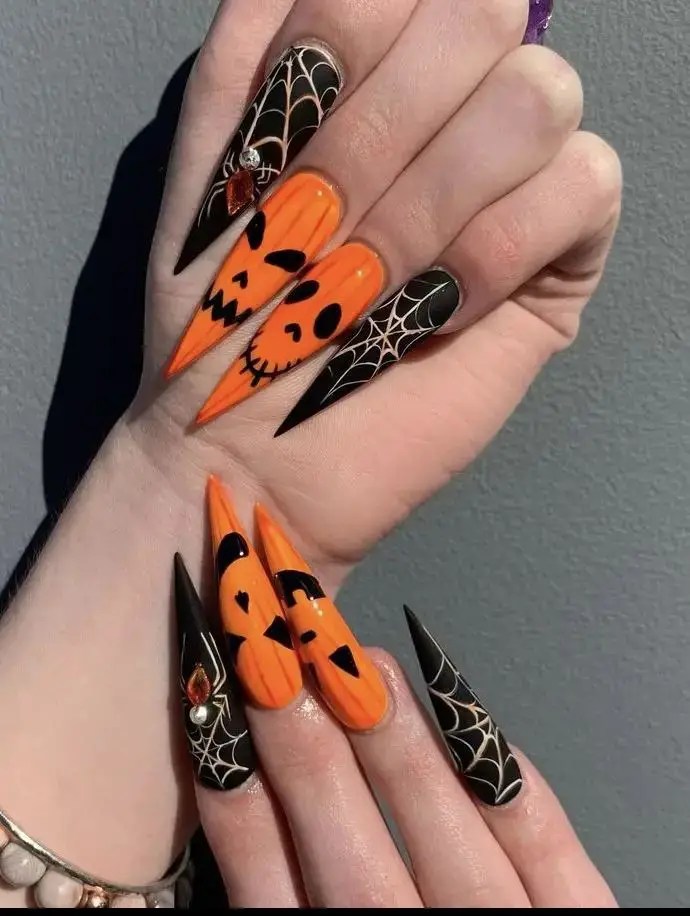 Creepy Halloween nails with orange and black accents