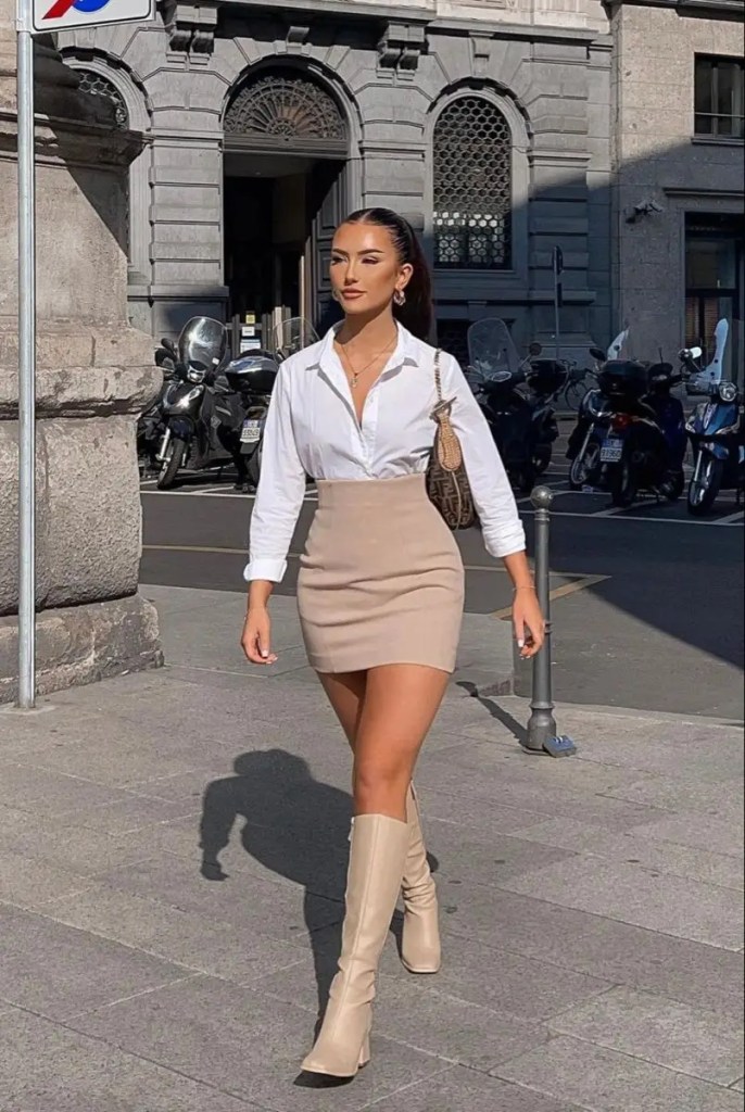 a lady wearing a short skirt with matching thigh-high boots