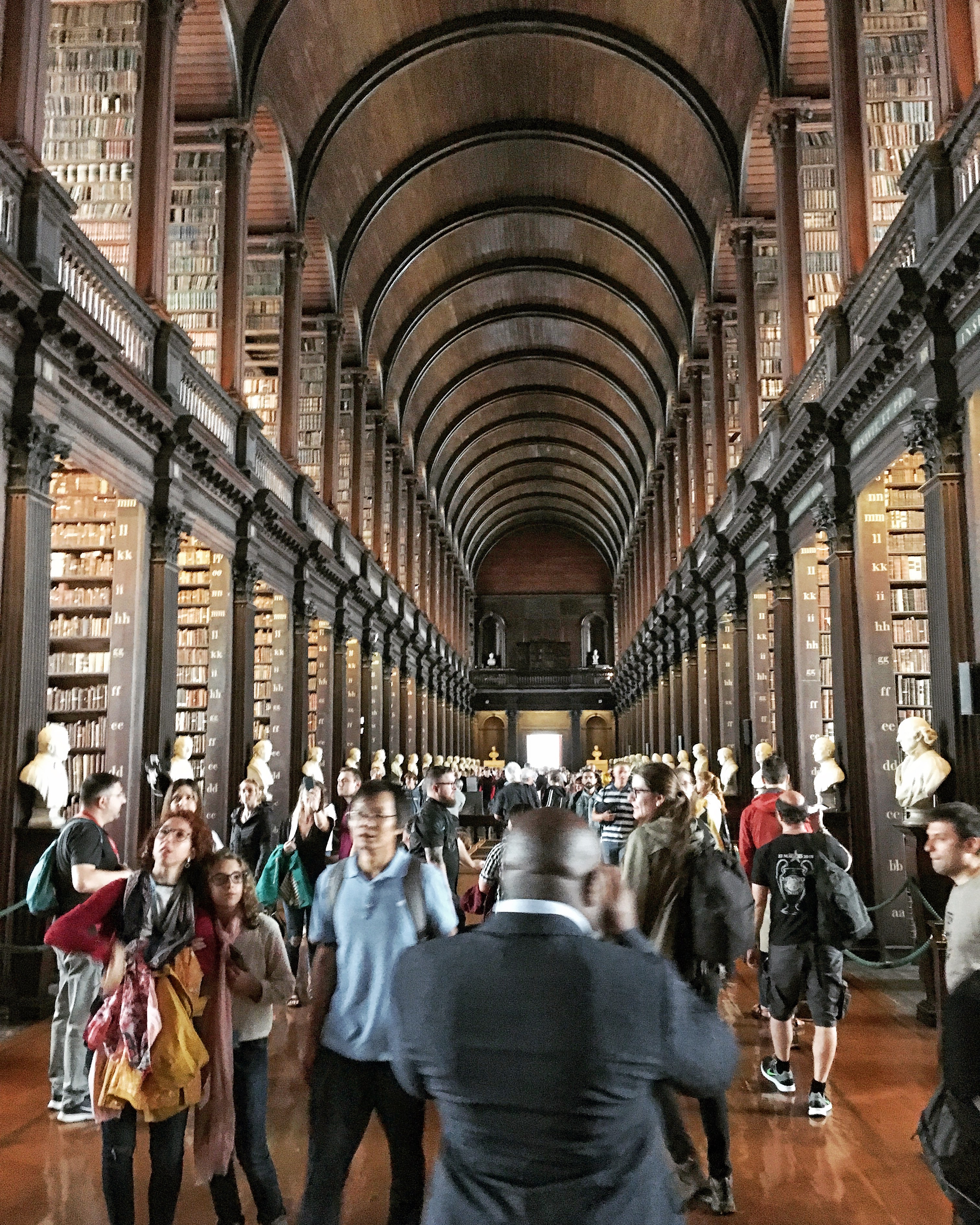 Inside of the Trinity College Library in Dublin, with rows of old books