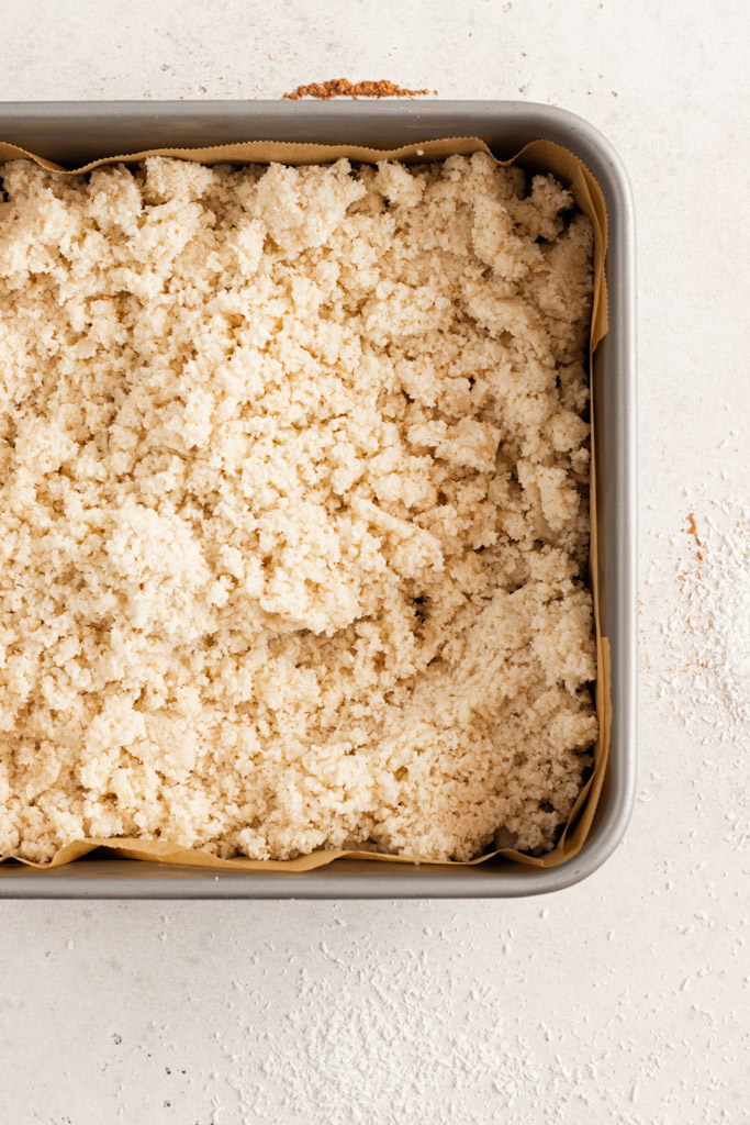 The coconut centre tipped onto the base, in the cake tin.