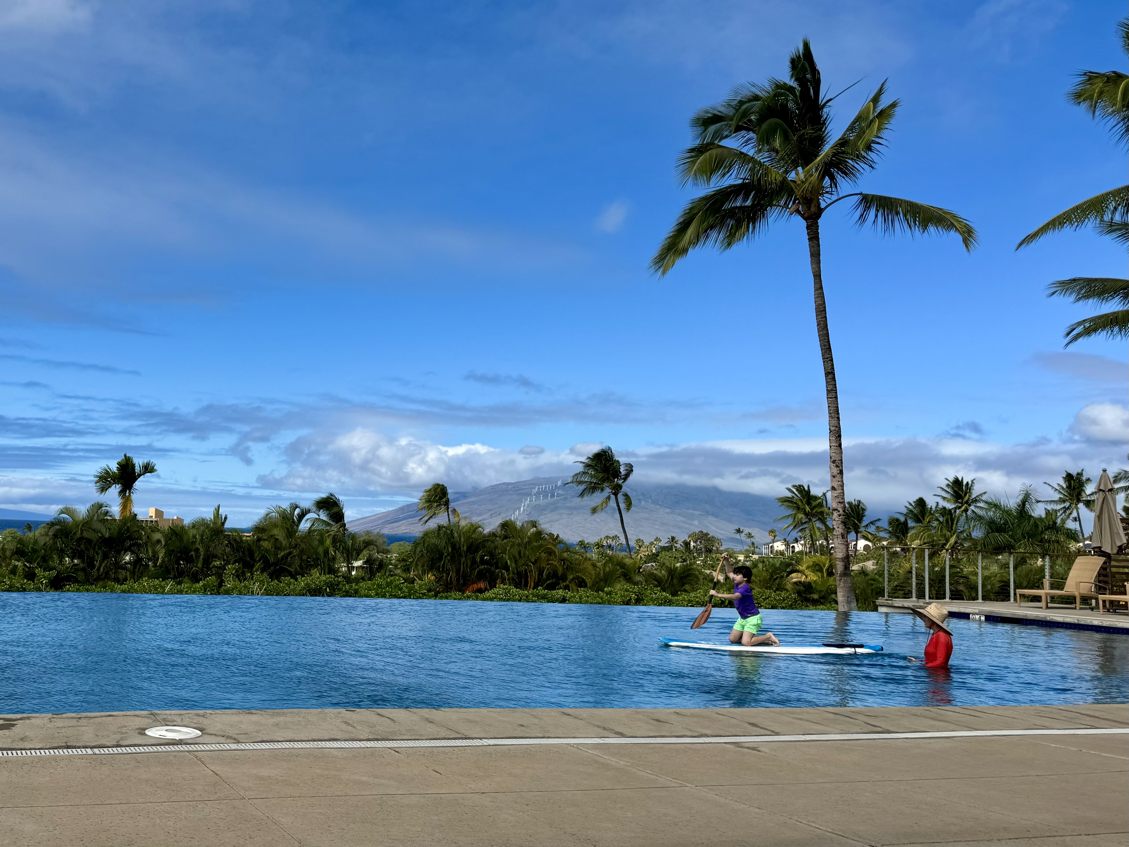 Child learning canoe foundations at pool in Kihei, Maui with cpr-certified swim coach