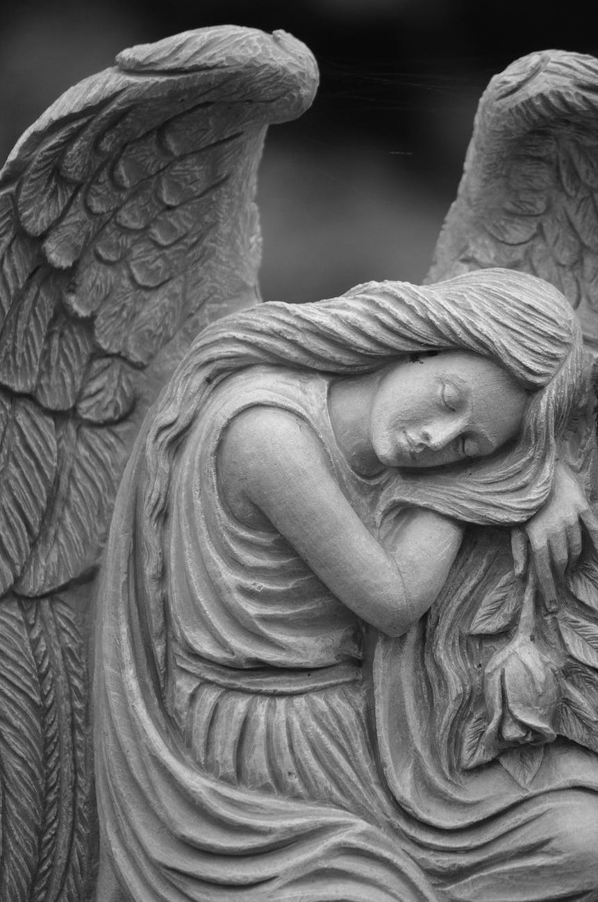 grayscale photo of a sleeping angels statue