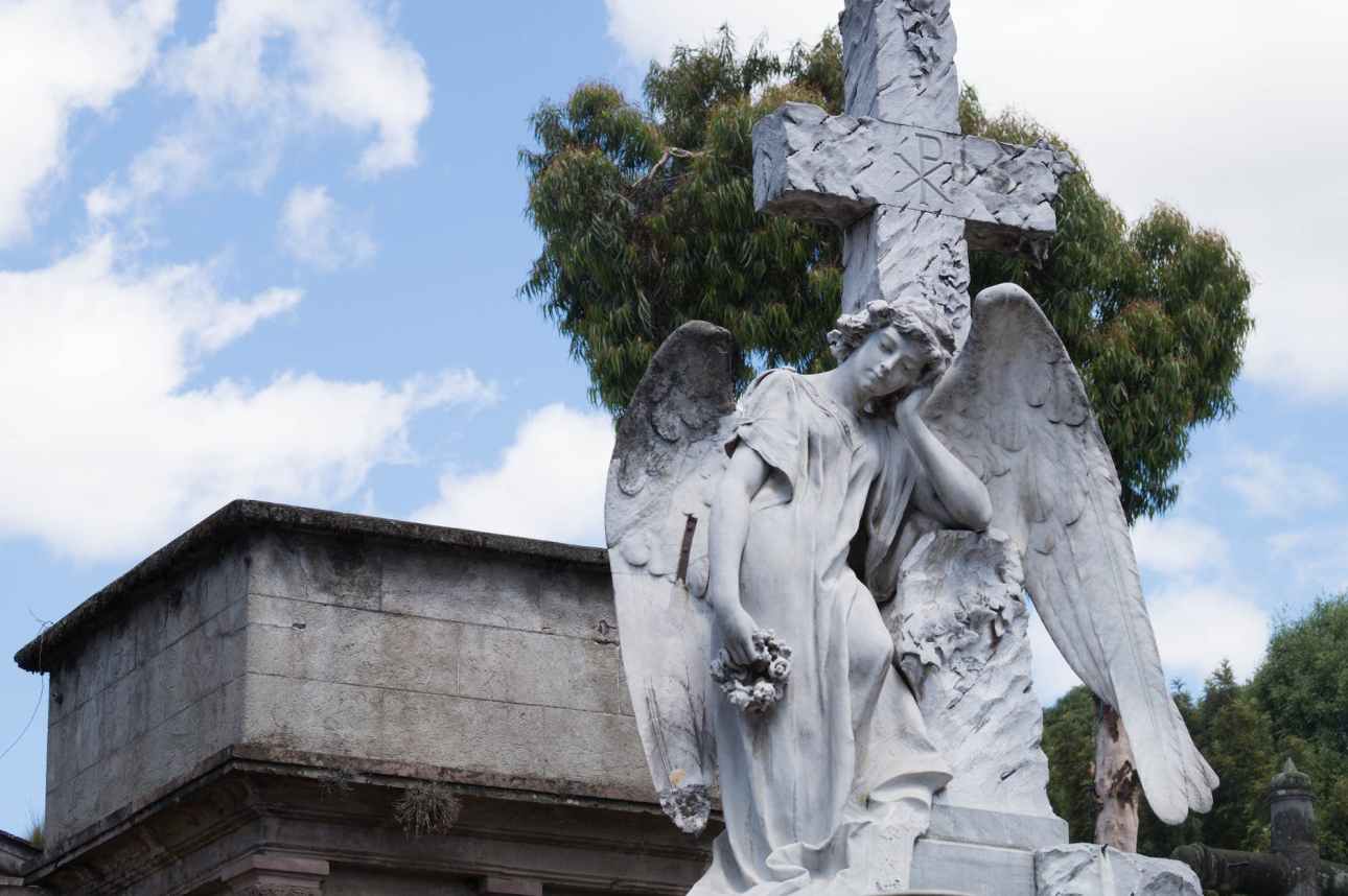 statue of angel and cross