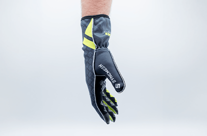 Close-up of a black and neon yellow sports glove (Smith) suspended in mid-air.