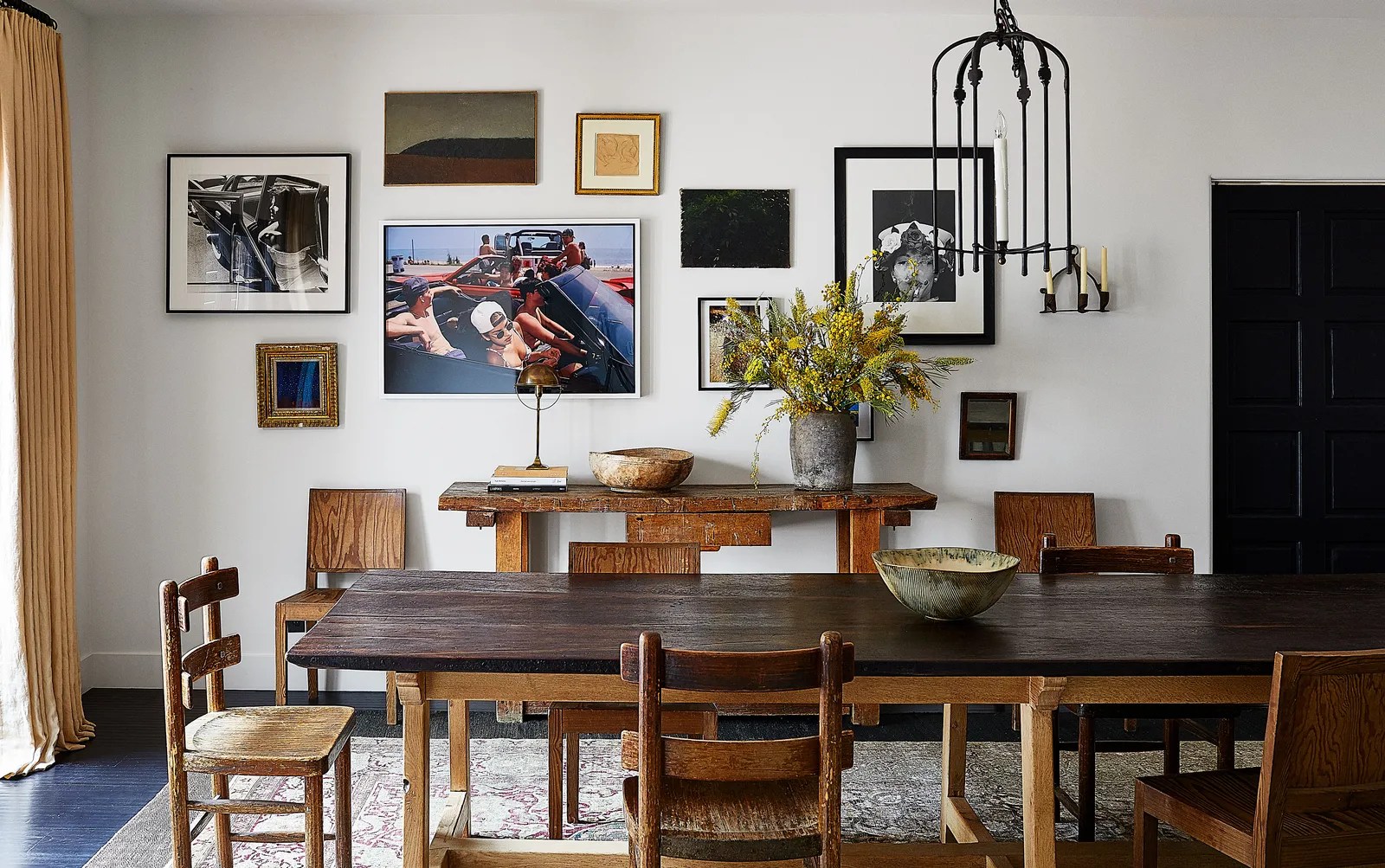 A Waldo’s Designs iron chandelier hangs above a walnut-and-oak dining table; 1930s Axel Einar Hjorth chairs from Lief. By William Abranowicz