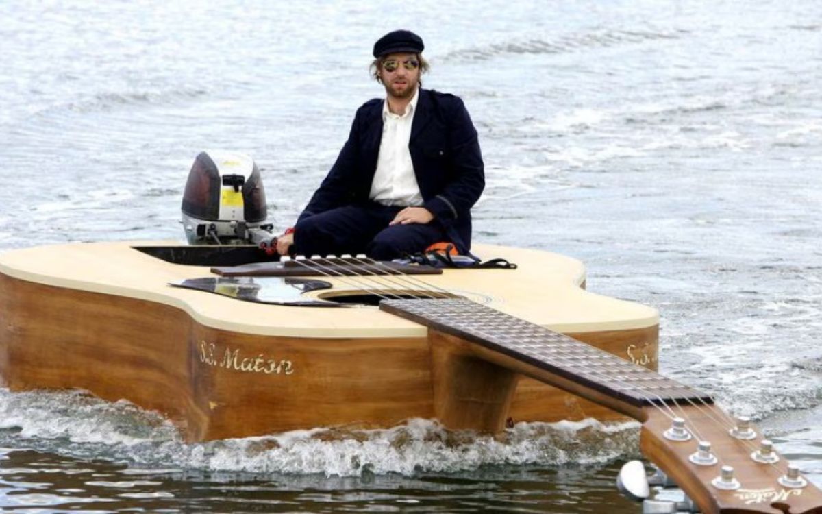 Yes, That Guitar is indeed functional as a boat. It was designed specifically for this music video and driven around Glebe.
