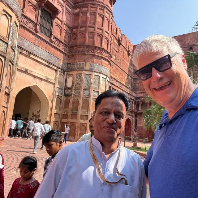 American tourist with guide exploring Agra Fort during 2 Day Delhi Agra Tour with Jaipur Transfer