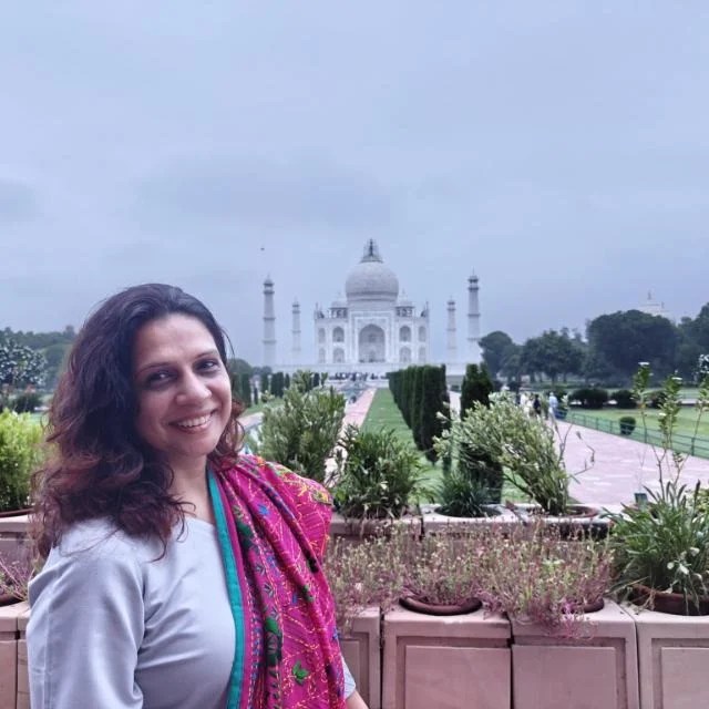 Solo traveler exploring the Taj Mahal at sunrise with soft golden light on the white marble, peaceful atmosphere, and light crowd near entrance, Agra India – Taj Mahal Cabs travel guide
