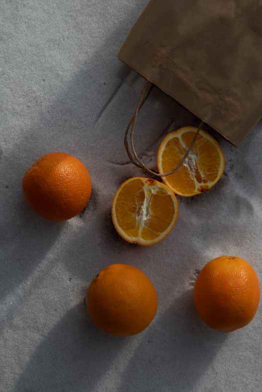 fresh oranges on sand ground