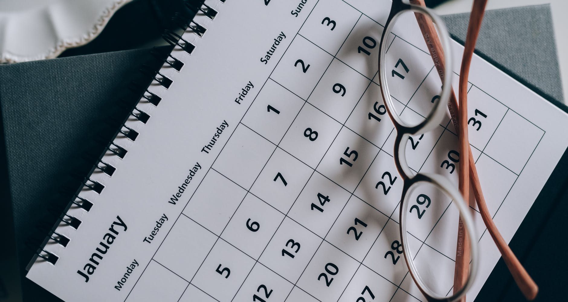 brown framed eyeglasses on a calendar