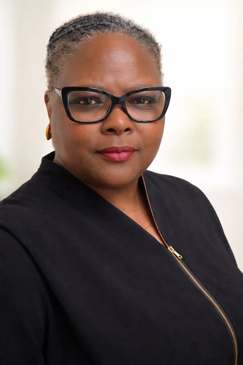 Confident woman with glasses, serious expression
