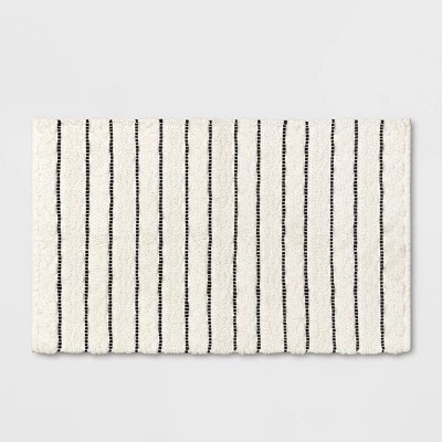 Be it a stunning chandelier, lovely sconces or dazzling pendants, lighting sets the tone and the mood. striped bath rug white black opalhouse