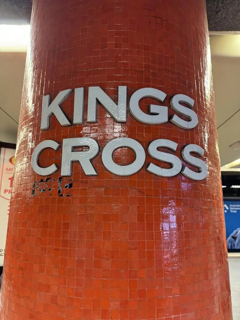 Kings Cross Station orange tiled column and heritage signage in Sydney.