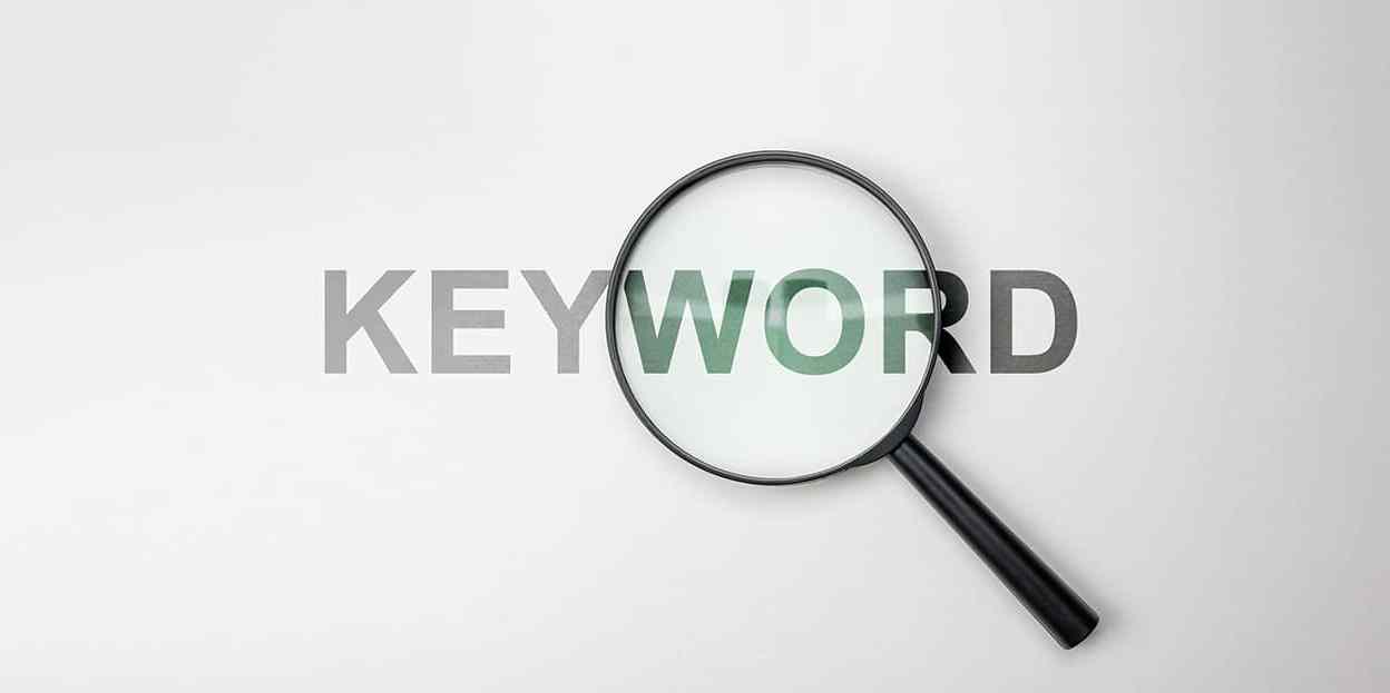 Magnifying glass over Keyword - SEO concept