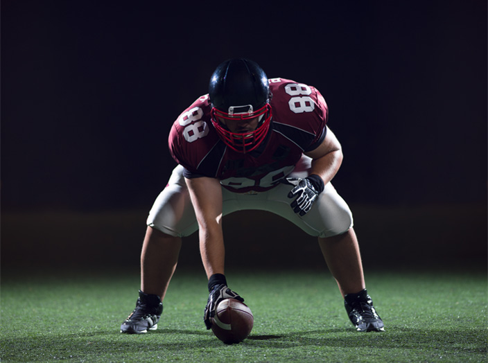 football player preparing for snap