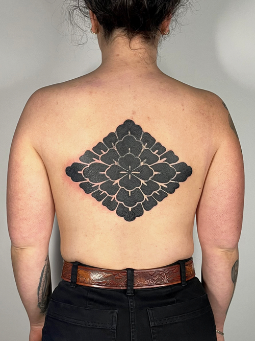 black & grey blackwork and ornamental tattoo on the back