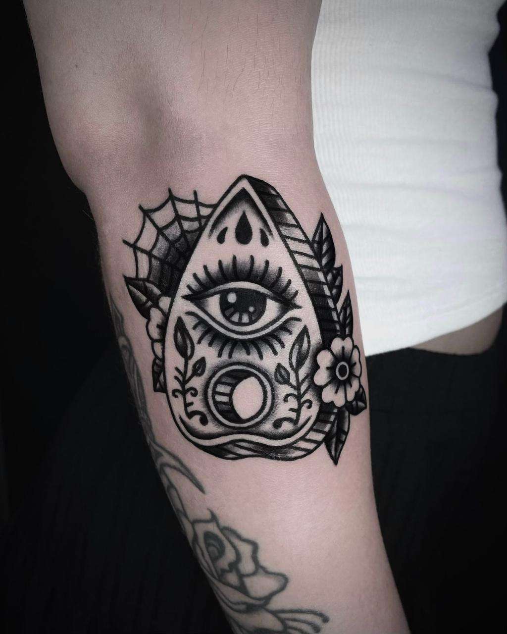 black & grey blackwork tattoo of eye on the forearm