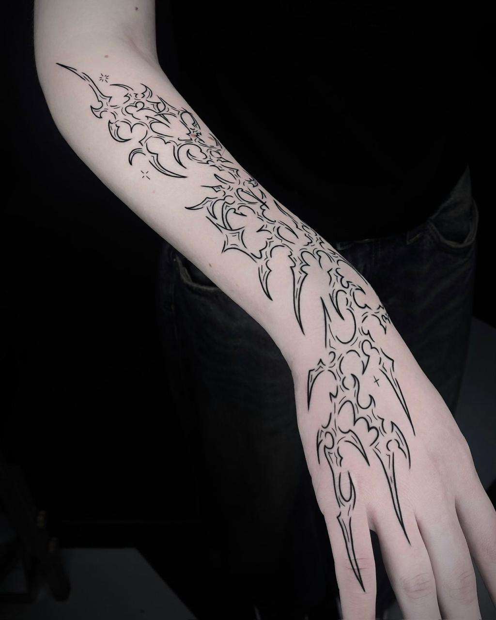 black & grey fine line tattoo of flower on the hand