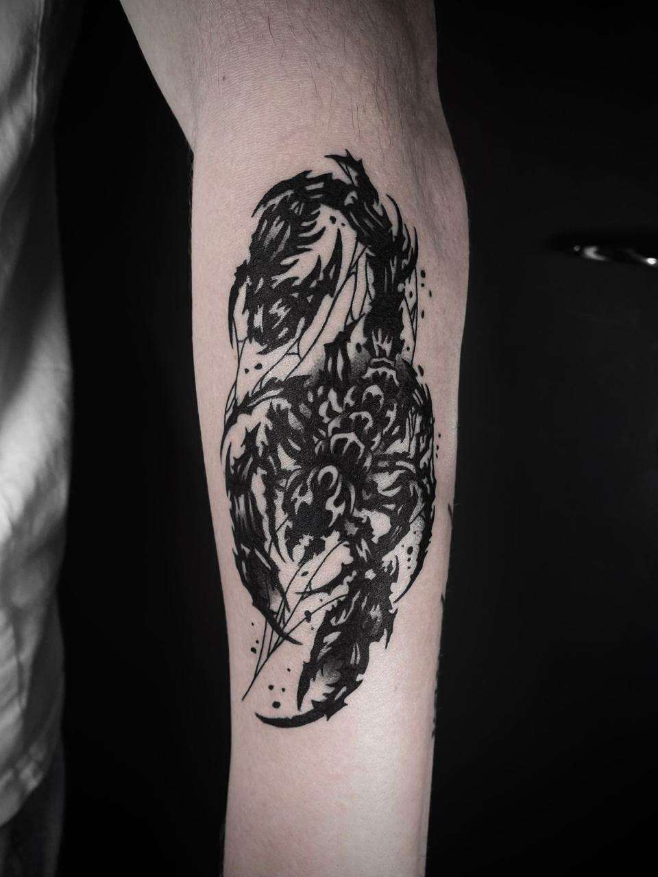 black & grey blackwork tattoo on the forearm
