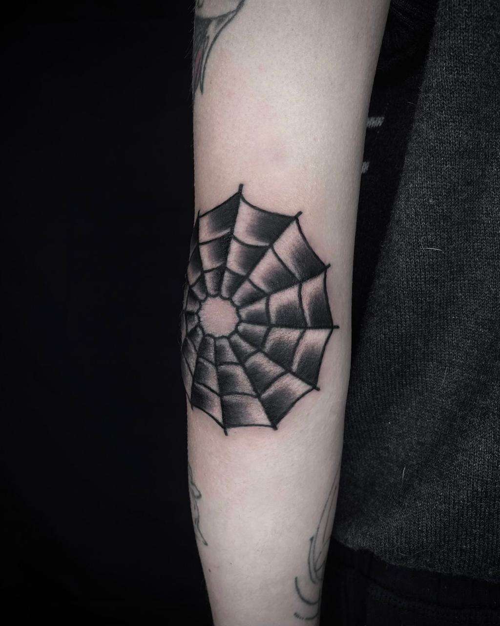 black & grey blackwork tattoo on the forearm