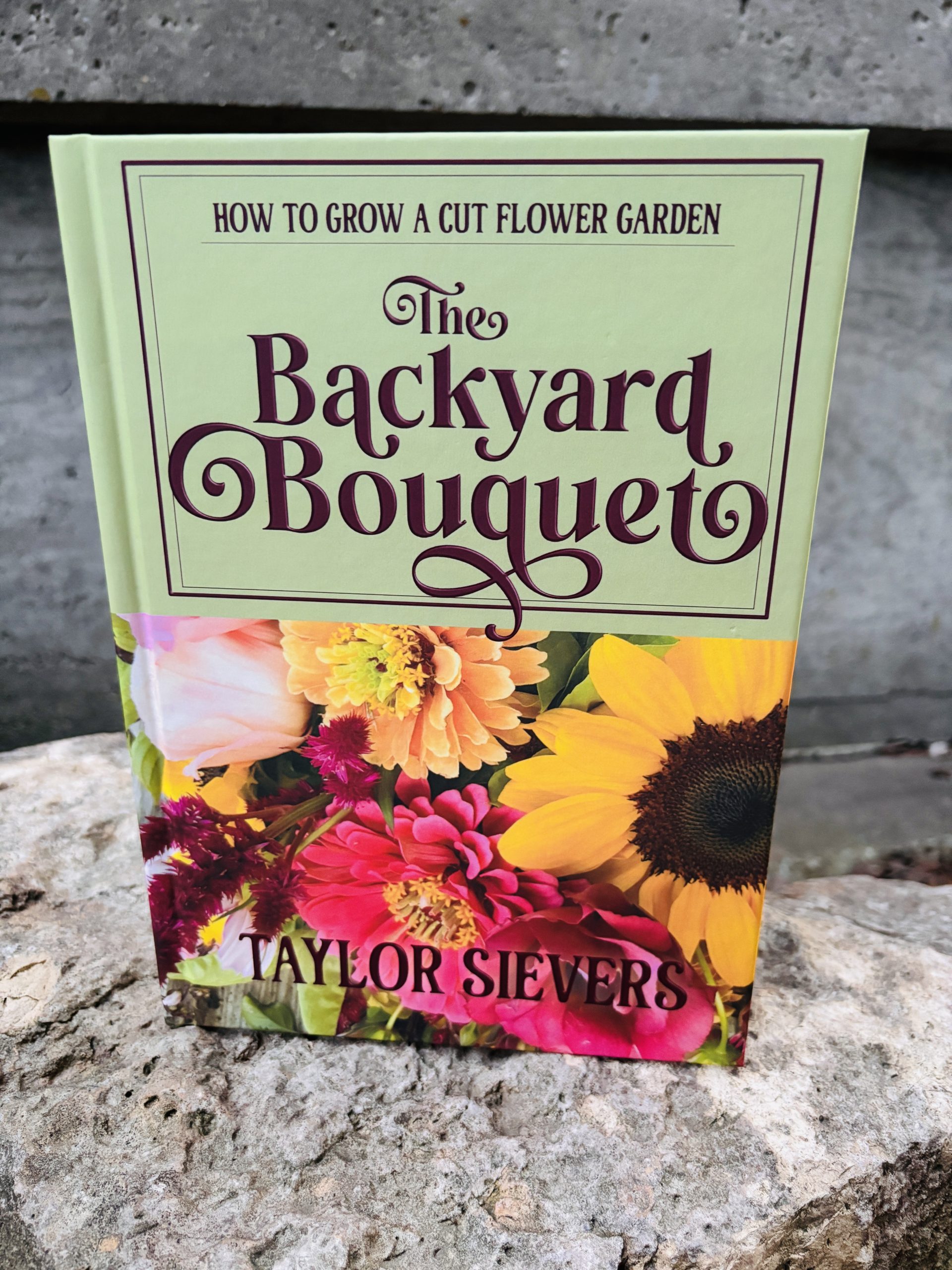 A hardback book with the title The Backyard Bouquet by Taylor Sievers
